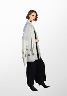 Woven from a very fine cashmere, this elegant ivory scarf is elevated by a hand-embroidered earings design in metallic beads from both ends. Incredibly stylish and comfortably warm for year-round wear, this scarf can be styled in many eye-catching ways, especially as an exclusive accessory to a wedding gown. Elegant Winter Festive Pashmina Shawl, Elegant Embroidered Scarves For Festive Occasions, Elegant Cream Scarves For Festive Season, Elegant Winter Festive Scarves, Elegant Cream Shawl Dupatta, Elegant Festive Scarves With Embroidered Border, Elegant White Pashmina Shawl For Festive Occasions, Elegant Cream Embroidered Shawl, Elegant White Pashmina Dupatta