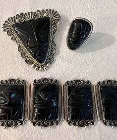 We have a rare gorgeous vintage silver black onyx Aztec jewelry set! The set comes with a brooch, ring, and bracelet, all stamped silver Mexico.  The set weighs together 5.8 ounces, the ring is roughly size 8. The band is a little bent unfortunately but still wearable. Please see attached photos for condition of the pieces. The set will need a goo polish and does have some markings/ scratched due to age of the set. The brooch size is 2 1/2 inches, the bracelet opened 7 1/2 inches long. Closed 3 Art Deco Sterling Silver Cabochon Jewelry, Vintage Silver Jewelry With Black Enamel, Antique Black Jewelry With Polished Finish, Art Deco Black Engraved Jewelry, Black Victorian Sterling Silver Jewelry, Victorian Style Silver Onyx Jewelry, Victorian Silver Onyx Jewelry, Victorian Black Sterling Silver Jewelry, Victorian Style Black Sterling Silver Jewelry