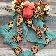 a wreath made out of fabric with flowers and leaves