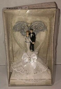 a wedding cake topper in a box