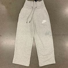 NWT Nike CI1174-050 Women's Sportswear Rally Sneaker Pants Standard Fit Grey XS Details: 100% Authentic Style number: CI1174-050 Color: Grey Size: X-Small Material: 58% cotton / 25% rayon / 17% polyester Wide elastic waistband with exterior drawstring Side hand pockets for quick storage Standard fit Please consider the size chart on picture #10 and #11 as a reference  Size approximately: waist -12.5" one side; pant length - 37"; inseam - 24" MFSRP: $65 + tax About Us: Thank you for your interest Athleisure Bottoms For Gym During Sports Season, Sporty Pants For Sports In Spring, Sporty Pants For Spring Sports, Sporty Wide Leg Spring Joggers, White Wide-leg Gym Bottoms, White Wide Leg Gym Bottoms, Athleisure Full-length Sports Bottoms, Athleisure Joggers With Side Pockets For Sports, Full-length Sweatpants With Pockets For Gym