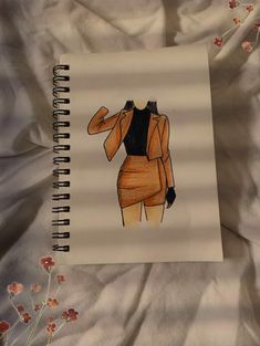 a drawing of a woman's jacket on top of a bed