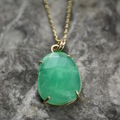 A large, natural rose cut chrysoprase in a freeform cabochon shape, this bright, apple-green chrysoprase is set in a handmade, minimalist, 100% recycled, 9ct gold prong setting with an open back - it's all about the stone. Suspended by twin jump rings, from a solid, 9ct gold diamond cut belcher chain, the pendant can be bought on its own to wear on a different chain if desired.  DETAILS Natural chrysoprase freeform rose cut cabochon approx: 19mm x 15mm x 4mm Pendant (including jump rings): 26mm Green Chrysoprase Oval Pendant Jewelry, Chrysoprase Oval Pendant Necklace As Gift, Oval Chrysoprase Gemstone Necklaces, Oval Chrysoprase Necklaces With Natural Stones, Oval Chrysoprase Natural Stone Necklace, Oval Chrysoprase Gemstone Necklace, Chrysoprase Gemstone Oval Pendant Necklace, Chrysoprase Emerald Necklace For Gift, Chrysoprase Necklace With Large Stone As Gift