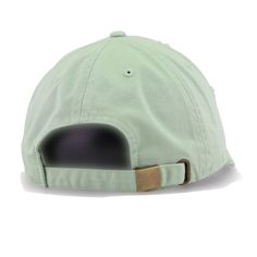 a light green hat with a black patch on the side and a brown brimmed visor