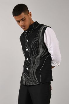 Black bundi with placement thread work and front button closure.
Components:1
Embroidered
Neckline:Mandarin Collar
Sleeve Length:Sleeveless
Fabric:Cotton Silk
Color:Black
Chest welt pocket
Closure: Front buttons
Note: Inner shirt and pant worn by the model is not for sale - Aza Fashions Menswear Indian, Indian Wedding Clothes For Men, Nehru Jacket For Men, Indian Groom Wear, Fancy Shirt, Kurta Patterns, Wedding Outfit Men, Indian Men Fashion, Nehru Jacket