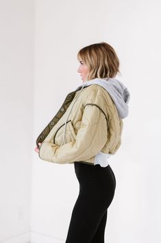 If you've never believed in love at first sight....we know this jacket will change your mind. In short......it's a quilted hoodie crop jacket with contrasting olive detailing with a gray hood. In long....it's got quilted texture that takes this jacket to the next level. It's a crop fit that screams style icon! It's a light olive color with contrasting dark olive detailing throughout which takes it up a few more notches because it's eye catching and dang cute! The 'sweatshirt' hood is gray and de