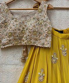 Mustard Yellow Georgette lehenga embellished with floral hand embroidered buttis and a shimmering gold border teamed with a beige gold raw silk blouse intricately hand embroidered with mirror, resham, zardozi, beads and cutwork details. Completed with a mustard yellow soft net dupatta with mirror work highlights and a gold zari border Composition : Lehenga - Georgette, Blouse - Raw Silk, Dupatta - Soft Net All products can be customised for sleeves, length of blouse and neck design Delivery : 2-4 weeks as the product is hand crafted. Check Size Guide or choose MySize for free customisation (All Sizes above XL can be made at 15% additional cost) For more information and sizes please contact fabiliciousfashion@gmail.com or visit our Copenhagen studio.About the Designer : Priti Sahni started Beige Mirror, Indian Clothes Women, Designer Dresses Elegant, Raw Silk Blouse, Mirror Work Lehenga, Raw Silk Lehenga, Georgette Lehenga, Long Gown Design, Floral Lehenga