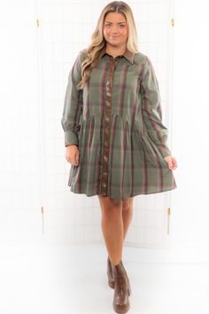 Elevate your fall wardrobe with the THML Plaid Faux Leather Trim Button Down Dress, boasting a classic brown, green, and burnt orange plaid pattern adorned with chic faux leather trim and buttons down the front. Perfect for the autumn season and Thanksgiving gatherings, this dress offers a slightly large fit, ensuring a comfortable yet stylish ensemble that exudes timeless charm and modern sophistication. Features: Classic brown, green, and burnt orange plaid pattern for a stylish autumn look. C Fitted Plaid Dress With Buttons For Fall, Long Sleeve Brown Plaid Dress For Fall, Casual Brown Plaid Dress For Fall, Fitted Collared Plaid Dress For Fall, Fall Plaid Dress For Workwear, Fall Plaid Dresses With Buttons, Plaid Button-up Dress For Fall, Fall Button-up Plaid Dress, Fall Plaid Button-up Dress