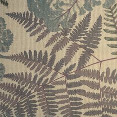 a close up view of some green and brown leaves on a white background with blue flowers