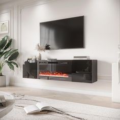 a living room with a large television mounted on the wall and a fire place in front of it