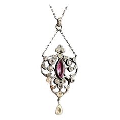 A stunning Antique Edwardian era, Belle Epoque sterling silver paste pendant necklace. It has a large pretty lavalier style pendant drop suspended from a small length of chain set with old diamond paste stones and a single Amethyst paste, the pendant has a further drop suspended from the base giving it lots of movement and sparkle. The main pendant is attached to a paste jeweled bale on the original fine link sterling silver chain. It has a spring ring fastener. A truly stunning piece of antique Victorian White Gold Pendant Necklace, Antique White Gold Pendant Necklace, Antique White Gold Diamond Pendant Necklace, Antique Silver Diamond Necklace, Victorian Silver Diamond Necklace With Rose Cut, Victorian Silver Diamond Necklace With Rose Cut Diamonds, Antique Rose Cut Diamond Pendant Necklace, Vintage Rose Cut Diamond Pendant Necklace, Vintage Pendant Necklace With Rose Cut Diamonds