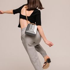 The new Sera Tall Tote is designed to carry your daily essentials, it can easily fit a large phone (like iPhone 15 Pro Max), mini wallet or cardholder, keys, lipstick, etc.Its exterior design is a surrealist dream, reminiscent of a maze-like structure protruding outwards, with sharp, clean lines, and a 3D façade. It has a suede drawstring top, securing your belongings on the go.Folding inwards like an accordion and then stretching outwards to store those last-minute belongings. The Sera Tall Tot Modern Rectangular Phone Bag With Removable Pouch, Modern Phone Bag With Removable Pouch, Modern Phone Bag With Removable Pouch For Evening, Modern Evening Phone Bag With Removable Pouch, Modern Square Phone Bag With Cell Phone Pocket, Modern Square Phone Bag For Everyday Use, Versatile Evening Rectangular Phone Bag, Versatile Rectangular Evening Phone Bag, Modern Evening Bag With Card Slots