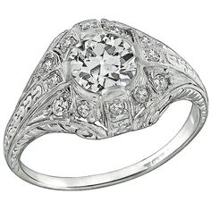 Handcrafted from the Art Deco era, this ring is centered with a sparkling GIA certified circular brilliant cut diamond that weighs 0.93ct. graded J color with VS2 clarity. The center diamond is accentuated by dazzling round cut diamond accents. The top of the ring measures 12mm by 16mm. It is currently size 7 3/4, and can be resized. Inventory #89708ARSS Platinum Engagement Ring, Platinum Diamond Engagement Rings, Platinum Engagement Rings, Art Deco Engagement Ring, Art Deco Diamond, Art Deco Era, Jewelry Rings Engagement, Vintage Engagement Rings, Round Cut Diamond