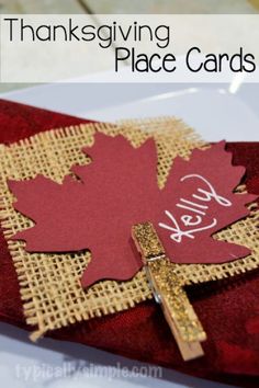 a red and gold place card with a cross on it that says hello fall leaves