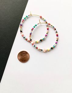 Large and colorful, beaded hoop earrings. Light weight with a bright, summer-y mix of colors. Made with a high quality mix of gorgeous seed beads. ✨Each piece is handmade to order and one-of-a-kind with variations in bead order.✨ Gold plated, 45 mm (1.75 inches) hoops. Looking for smaller sizes? Small Beaded Hoops: https://etsy.me/3bs8SKz Medium Beaded Hoops: https://etsy.me/3xXuyrh 🌎 Packaging 🌎 To be environmentally responsible about packaging we will package orders together in the same box. Trendy Colorful Beaded Hoop Earrings For Gifts, Multicolor Hoop Earrings With Round Beads, Colorful Beaded Round Hoop Earrings, Multicolor Beaded Hoop Earrings With Spacer Beads, Multicolor Hoop Beaded Earrings With Spacer Beads, Adjustable Hoop Beaded Earrings With Colorful Beads, Adjustable Hoop Earrings With Colorful Beads, Multicolor Hoop Earrings With Tiny Beads, Multicolor Hoop Jewelry With Spacer Beads