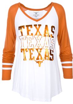 Display your Texas Longhorns spirit in this Texas Burnt Orange T-Shirt! This Texas Hera Long Sleeve T-Shirt makes a great layer for cooler nights cheering on the Longhorns. Featuring a screen print foil graphic on center front, this Texas Longhorns Long Sleeve LS Tee is a must-have for any fan. Hook Em Horns! Relaxed fit, Drapey V neck, Self-fabric sleeve stripes, Screen print team graphic, 90% COTTON / 10% POLYESTER White V-neck Top With Contrast Stripes, Collegiate Striped Tops With Team Name, Three Stripes Tops For Team Spirit Fan Gear, Long Sleeve Sports Tops With Contrast Stripes, Sporty White Tops With Striped Sleeves, White V-neck Top For College, White Sports Fan Top For Fall, White Tops For Fall Sports Fans, White Top With Three Stripes For Fall