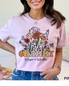 Custom Grammy Shirt & Grandkids Names Mother's Day Gift Grammy Wildflowers TShirt Grandmas Garden Shirt Personalized Floral Tees Grammy Gift This Shirt is everything you've dreamed of and more. It feels soft and lightweight, with the right amount of stretch. It's comfortable and flattering for both men and women. ➡️BELLA + CANVAS 3001 ➡️ Sizes: Available up to 3XL. SEE SIZE CHART in the photo section of this listing. ➡️ Printed And Shipped From Canada / USA ➡️ Printing Method: DTG ➡️ Care: Machi Floral Tees, Grammy Gift, Garden Shirt, Grandmas Garden, Gardening Shirts, Floral Tee, Unique Christmas Gifts, Mother's Day Gift, Mother's Day Gifts