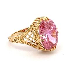 Large Oval Pink Cubic Zirconia Yellow Gold Filigree Ring Ring Size: 7.75 Metal Content: 14k Yellow Gold Gemstone: Cubic Zirconia Carat: 5 Size in mm: 14 x 10 Weight: 5.7 Grams Back of Ring width: 2mm Stamps: 14k DQCZ Condition: Excellent Pre-owned Condition Each piece is thoroughly examined and refinished as needed by our professional jewelers, tested to guarantee metal content,  graded by our in-house GIA (Gemological Institute of America) Graduate Gemologist, and inspected for quality before being carefully packaged and promptly shipped. Thank you for taking the time to shop with us! We have hundreds of more listings, with more being added every week! From necklaces to bracelets, the classics and trendy.  We are likely to have something you and your loved ones will cherish. Please contac Pink Gold Jewelry With Center Stone For Formal Occasions, Formal Pink Gold Jewelry With Center Stone, Classic Pink Gold Rings With Center Stone, Formal Oval Pink Sapphire Ring, Oval Pink Gold Diamond Ring For Formal Occasions, Formal Pink Gold Rings With Accent Stones, Formal Oval Pink Gold Diamond Ring, Pink Oval Ring For Formal Occasions, Formal Pink Gold Ring With Center Stone