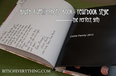 an open book with handwritten text on the cover and inside it, sitting on a green table