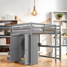 a bunk bed with a desk underneath it and bookshelves in the back ground