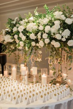 the wedding table is set up with candles and flowers