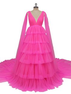 a pink dress with long sleeves and tiered tulle skirt on a mannequin