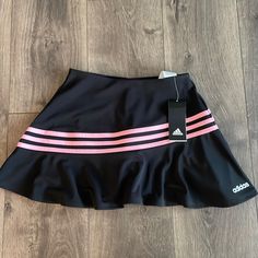 a black skirt with pink stripes on the side