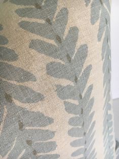 a close up view of a lamp shade with leaves on the bottom and back of it