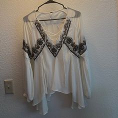 Tie Front V-Neck Long Sleeve Blouse By Free People. Worn A Handful Of Times And Is In Great Condition. Elegant V-neck Peasant Top For Fall, Chic V-neck Festival Tops, Bohemian Flowy V-neck Top, Chic Flowy V-neck Peasant Top, Spring Bohemian V-neck Top, Elegant V-neck Peasant Top For Brunch, White Long Sleeve V-neck Top For Summer, White V-neck Top For Fall, V-neck Festival Tops For Fall