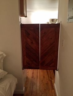 an open door leading to a bedroom with wooden floors