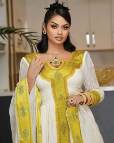 This elegant golden Habesha dress displays traditionally unique craftmanship with modern finishing and pattern style. The gorgeous essence of the dress offers beautiful look for any special occasions planned. Material Cotton Menen Thread Estimated delivery : 1 week to 2 weeks Contact WhatsApp +1(304)-306-2784Email: contact@ethiopian.store Traditional Yellow Dress For Ceremonies, Elegant Ceremonial Dress With Pallu, Yellow Dresses For Eid And Traditional Ceremonies, Gold Dress With Traditional Patterns For Wedding, Elegant Ceremonial Dress With Zari Work, Traditional Gold Kaftan For Festivals, Traditional Gold Floor-length Kaftan, Traditional Gold Festive Dresses, Traditional Gold Dresses For Festive Occasions