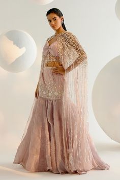 Onion pink cape with crystal embellishment and pearl, sequin, metal chain embroidery. Paired with embroidered padded blouse and attached cancan fishcut lehenga. - Aza Fashions Glamorous Organza Sets With Pearl Embroidery, Festive Lehenga With Pearl Embroidery And Cape Sleeves, Embellished Organza Sets With Cape Sleeves, Pink Party Sets With Cape Sleeves, Glamorous Organza Lehenga With Pearl Embroidery, Wedding Lehenga With Pearl Embroidery And Cape Sleeves, Organza Lehenga With Cape Sleeves For Wedding, Glamorous Pink Lehenga With Sheer Dupatta, Pink Hand Embellished Organza Lehenga