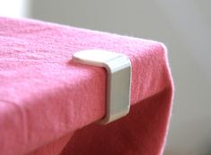 a pink couch with a white handle on it