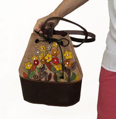 You'll Love This Flowers Backpack! Want a stylish, unique backpack?  With its beautiful colorful flower design and genuine leather, you'll stand out in style. Handmade with love, it's perfect for women who want to look chic and stay organized. 🌸 Special Embroidered Design: The colorful flower embroidery adds a touch of elegance and uniqueness to your look. 👜 Genuine Lamb Leather: Made with real, high-quality leather, this backpack is durable and long-lasting. 🌈 Colorful and Stylish: The brown Multicolor Leather Bucket Bag, Multicolor Leather Satchel Bucket Bag, Multicolor Leather Backpack, Multicolor Leather Standard Backpack, Multicolor Flower Shaped Shoulder Bag For Travel, Flower Shaped Multicolor Travel Shoulder Bag, Flower Shaped Multicolor Shoulder Bag, Multicolor Leather Shoulder Bag As Gift, Multicolor Leather Shoulder Bag For Gift