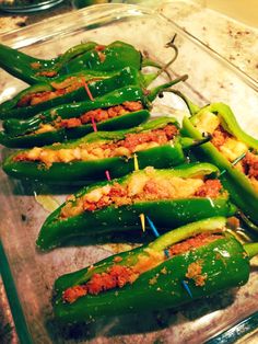 green peppers are stuffed with meat and seasoning on the side, ready to be cooked