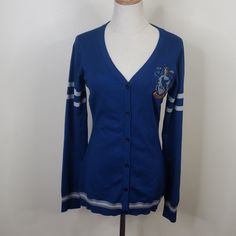 a women's cardigan sweater with an embroidered crest on the chest and sleeves