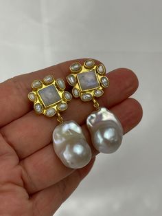 Indulge in the allure of natural beauty with our handcrafted gemstone and pearl earrings. Each earring features a stunning square-cut gemstone, available in mesmerizing moonstone, refreshing chrysoprase, or mystical labradorite. Encircled by delicate genuine rice pearls and embraced by a 22k gold-plated brass bezel, these earrings exude elegance and sophistication.Dangling gracefully beneath, a lustrous baroque pearl steals the spotlight. Crafted from high-quality cultured pearls, each pair boasts a magnificent 15mm x 20mm size (approximate). However, please note that the size and shape of the baroque pearls may vary, as nature gifts each pearl with its unique characteristics. Rest assured, the pearls you receive will mirror the exquisite quality showcased in our photos, albeit with slight Bohemian Pearl Jewelry, Unique Wedding Earrings, Unique Pearl Earrings, Baroque Earrings, Earring Bridal, Bridal Statement Earrings, Heart Throb, Rice Pearls, Baroque Pearl Earrings