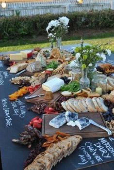 a table covered with bread, cheese and other foods