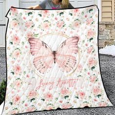 a woman holding up a quilt with a pink butterfly on it and the words, happy anniversary