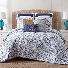 a blue and white comforter set with pillows