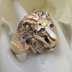 This Is A Very Cool Lions Head Ring! Crafted In 10k Yellow, Rose, And White Gold, There Is Wonderful Detail To The Face. The Eyes Are Synthetic Rubies And There Are Bright Cz's Along The Mane, As Well As A Large Cz Stone Held In The Jaws. Size 10-1/2 Measures Just Over 3/4" N-S (Approximately 21 Mm). 10.7 Grams **This Will Go Through The Poshmark Authentication Process.** *Please Ask Any Questions By Commenting Below. *I Generally Ship Within 24 Hours But Please Reach Out If You Need To Ensure E Lions Head, Lion Ring, Gold Lion, Head Ring, Mens Accessories Jewelry, Cz Stone, Yellow Rose, 10k Gold, Tri Color