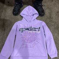 Purple Black And White Spider Hoodie With Stars Going Through Out The Hoodie Purple Hoodie Sweatshirt For Streetwear, Purple Sweatshirt For Winter Streetwear, Urban Purple Outerwear For Fall, Hooded Purple Sweatshirt For Streetwear, Purple Hooded Sweatshirt For Streetwear, Purple Hoodie For Streetwear, Winter Purple Hoodie With Letter Print, Purple Letter Print Sweatshirt For Streetwear, Trendy Purple Hoodie With Letter Print