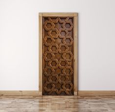 an open wooden door in the middle of a room with hard wood flooring and white walls