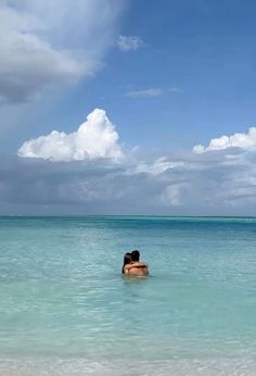 two people are swimming in the ocean together