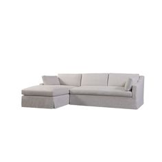 a white sectional couch with pillows on it's back and the seat folded out