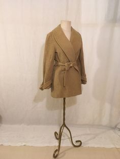 "vintage 1960s women's jacket Pendleton Woolen Mills 100% pure virgin wool solid beige color shawl collar acetate lining sash tie waist back waist cinch pleats buckle sash sleeve cuffs side pockets good vintage condition w/some age wear, some pock marks throughout/stains frayed and balding buckle fabric label size 10, see below measures, lying flat, shoulder-17\" waist-adjustable back waist side seam to side seam-17\" length-31\" sleeve-22 1/2\"     We do not offer returns or refunds unless something is grossly misrepresented. Please contact us within 2 business days of receiving to discuss any possible returns for this reason. We do not offer refunds for your shipping fees. Please feel free to contact us with any questions you may have about an item prior to purchase and we will gladly an Beige Wool Shawl Collar Outerwear, Fitted Beige Wool Coat For Fall, Fitted Beige Wool Coat With Notch Lapel, Beige Fitted Wool Coat With Notch Lapel, Vintage Wool Coat For Work, Fitted Beige Wool Coat For Spring, Vintage Fall Outerwear, Cream Shawl Collar Winter Outerwear, Cream Shawl Collar Outerwear For Winter