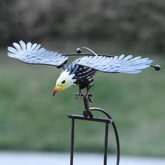 a statue of an eagle on top of a metal stand