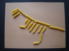 a piece of art made to look like a human body with yellow sticks sticking out of it