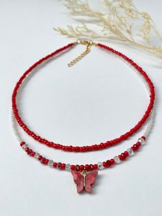 This dainty, layered necklace is beautifully crafted, and brings a whimsical touch to any outfit. Beautiful  re-beaded necklace made with seed beads and a red butterfly pendant. Each necklace is handmade and carefully crafted to ensure durability for everyday wear.  This two-layer necklace is attached with a crimp bead for a nice, neat look. The layers of the necklace differ by one inch in length, with an adjustable 2 inch extender chain (the size listed is for the SHORTER layer). I offer nine different lengths. If you would like a different length, please feel free to leave a message. My business thrives on Customer Satisfaction Please do not hesitate to reach me if there is something wrong with your purchase. I will try my best to make it right for you. Thank you for shopping JGBestBeade Adjustable Beaded Chain Layered Necklace Gift, Adjustable Beaded Chain Layered Necklace For Gift, Adjustable Layered Necklace With Colorful Beads For Gift, Adjustable Beaded Layered Necklace Gift, Trendy Beaded Clavicle Chain Necklace As Gift, Beaded Layered Necklace For Summer Gifts, Trendy Beaded Layered Necklace For Gifts, Adjustable Layered Necklace For Summer Gift, Trendy Adjustable Layered Necklace Gift