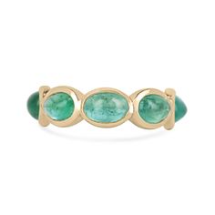 Introducing our exquisite Emerald Cabochon Eternity Band Ring, a timeless masterpiece for your collection. Seven alluring oval-shaped cabochon-cut emeralds, boasting a lush medium green color and semi-transparent clarity, elegantly encircle the band in individual bezel settings. Crafted in luxurious 14k gold, this ring is designed with both style and durability in mind, featuring a thoughtful gap at the bottom to ensure comfortable wear while safeguarding the precious gemstones. Available in size 6.5, this ring is a symbol of enduring elegance and sophistication. Setting Style: Bezel  Setting Material: 14K Gold Setting Weight: 3.0 Grams Main Stone: Emerald Shape: Oval  Count: 7 Weight: 3.60-Carats (Total) Clarity: Semi-Transparent  Color: Lush Medium Green Luster: Good Treatments: Natural, Emerald Eternity Band, Emerald Cabochon, Emerald Gem, Tiny Bow, Ringe Gold, Eternity Band Ring, Gold Band Ring, Semi Transparent, Green Emerald